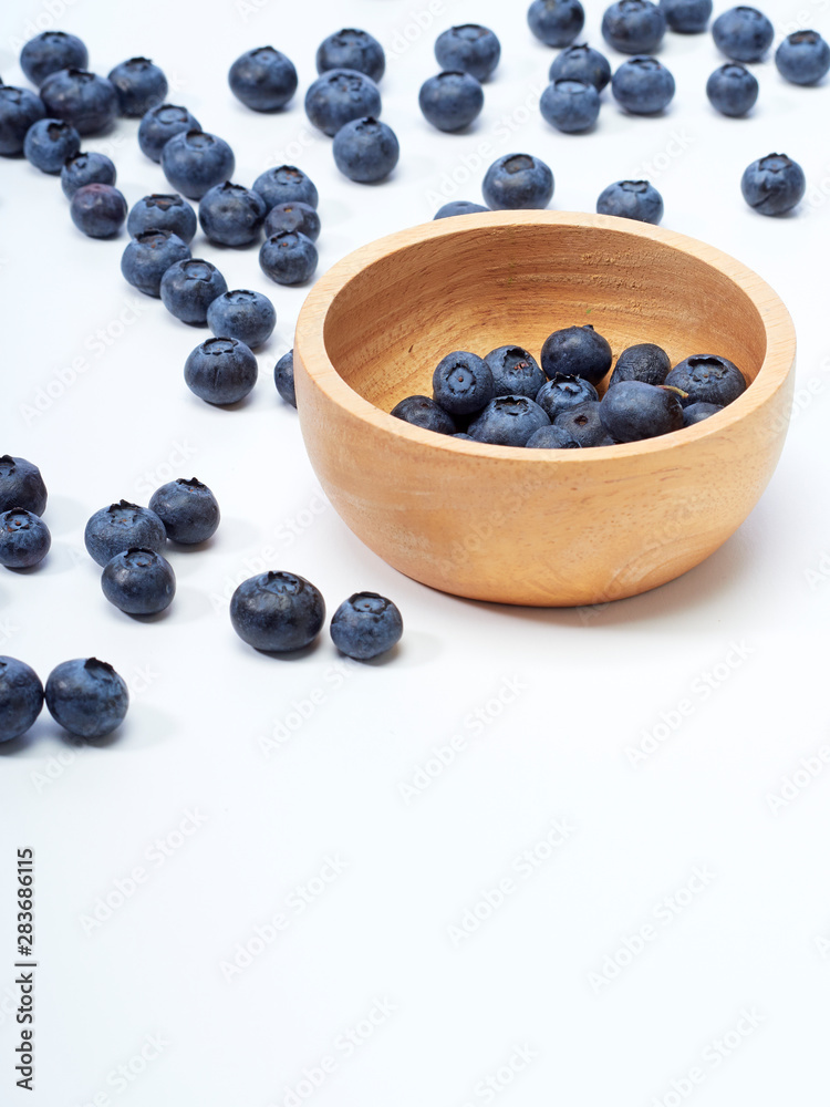 blueberry in wooden bowl on white background blueberry in wooden bowl on white background