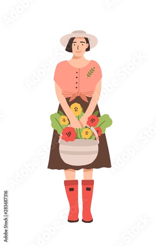 Cute smiling woman in rubber boots holding basket full of blooming flowers. Portrait of happy adorable young girl, florist or gardener isolated on white background. Flat cartoon vector illustration.