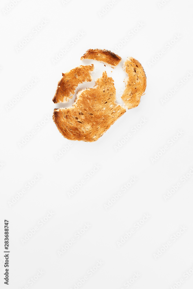 Broken slice of fried bread isolated on white. Broken slice of fried bread isolated on white.