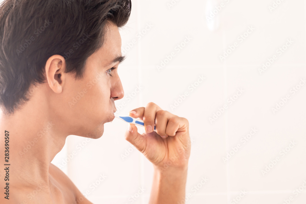 Because everyone sees your smile. Young man is getting ready for a new day. Copy space on the right side