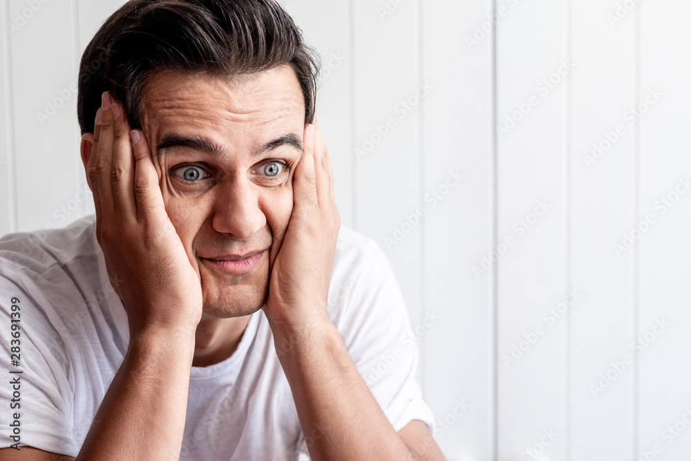 Am I dreaming?! Young guy looking shocked. Human emotions and facial expressions. Copy space on the right side Am I dreaming?! Young guy looking shocked. Human emotions and facial expressions. Copy space on the right side