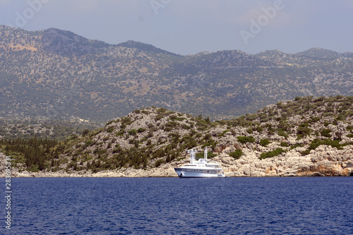 Yachts in the Mediterranean Sea on a background of rocky shores. Concept - travel by sea © yuryastankov
