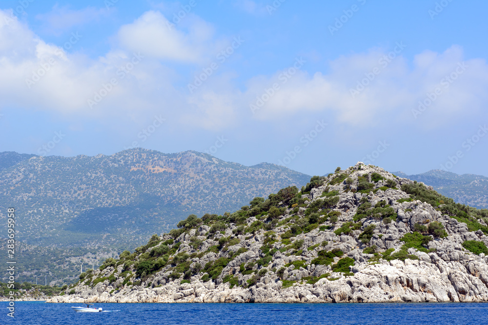 Rocky islands forested in the Mediterranean Sea. Concept - Tourism