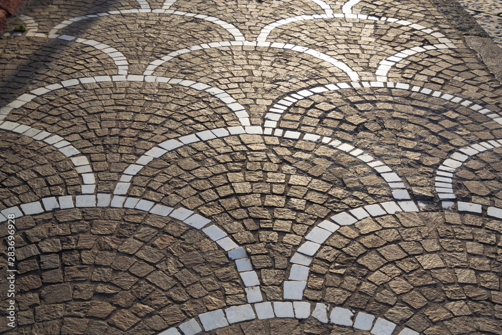 Abstract background of sunlight on the cobblestone pavement road surface
