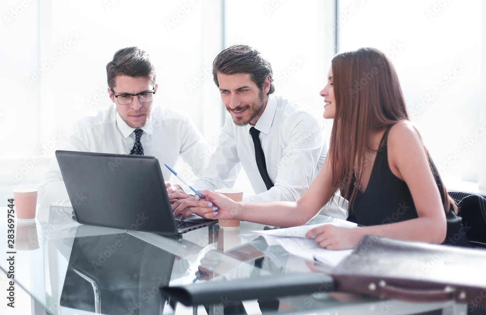 business team discussing online information in the office business team discussing online information in the office