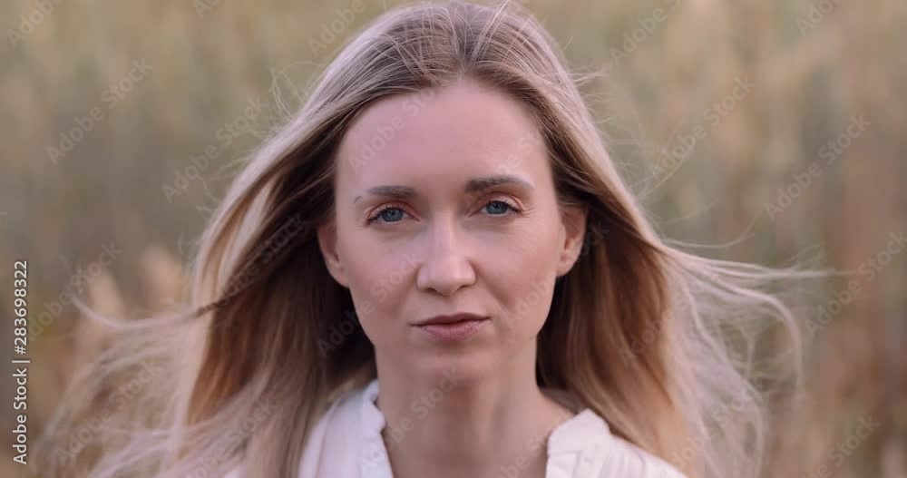large woman portrait on a background of rye field large woman portrait on a background of rye field