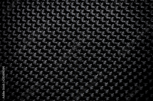 Black fabric canvas silk texture background. Abstract closeup detail of textile material wallpaper.