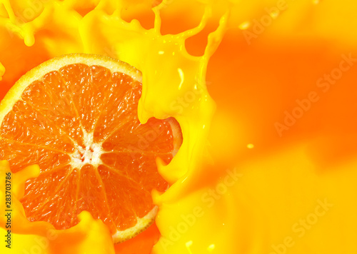 Orange fruit cut in half with orange juice splash