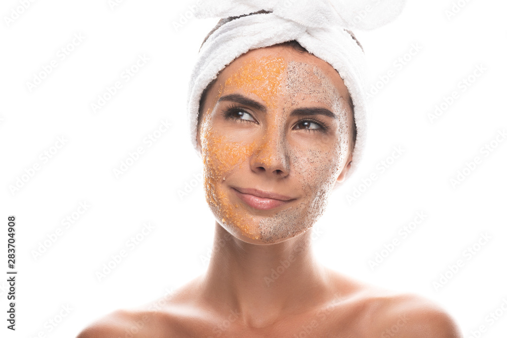front view of pensive young woman in cosmetic hair band with scrub on face isolated on white front view of pensive young woman in cosmetic hair band with scrub on face isolated on white