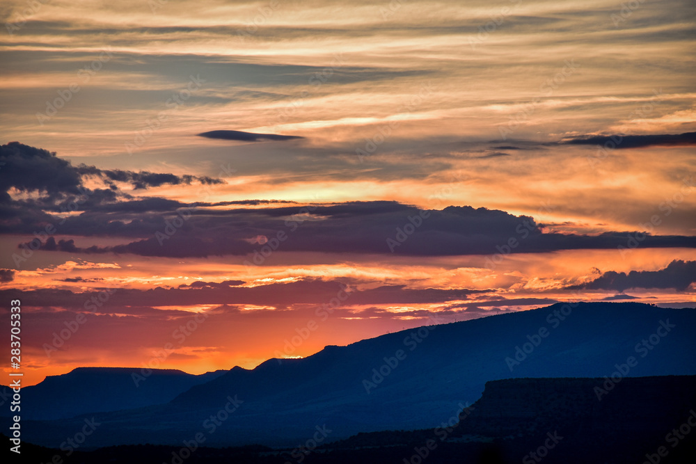 SUNSET WITH MOUNTAINS AND CLOUDS