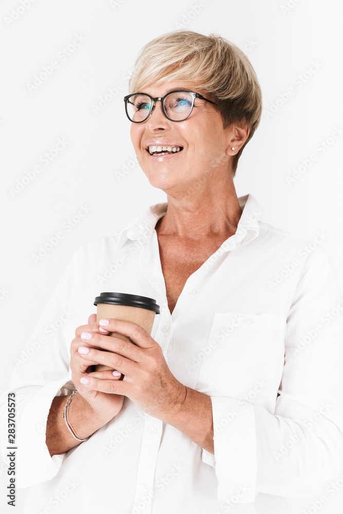 Portrait of beautiful adult woman wearing eyeglasses holding takeaway coffee cup
