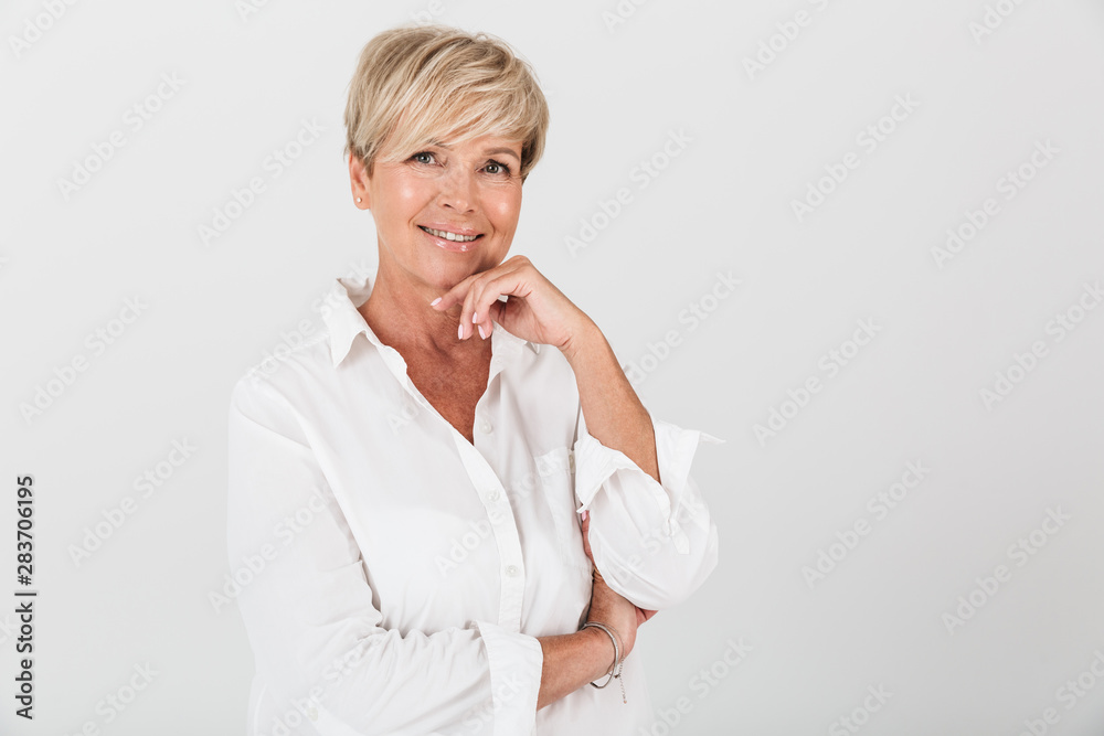 Portrait closeup of happy adult woman with short blond hair smiling at camera Portrait closeup of happy adult woman with short blond hair smiling at camera