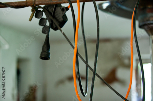 Cuadro en lienzo a hodgeplodge of electrical vintage cable hanging down a ceiling