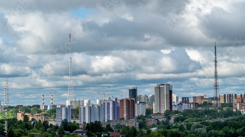 View of the new and old TV towers in Perm. Gloomy summer morning, rain clouds.