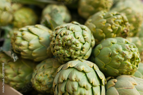 Fresh artichokes on market counter