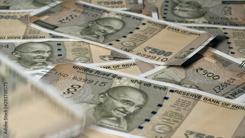 Closeup shot of Rupee 500 Indian currency notes falling on the table. 