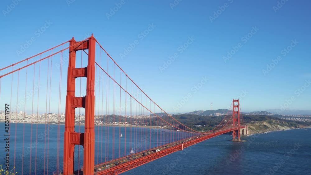 back view of young beautiful asian hiker traveler standing on mountain peak with backpack sightseeing Golden Gate Bridge San Francisco California USA. famous tourism attraction nature blue sky ocean back view of young beautiful asian hiker traveler standing on mountain peak with backpack sightseeing Golden Gate Bridge San Francisco California USA. famous tourism attraction nature blue sky ocean