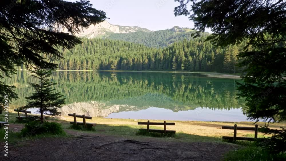Black Lake in Durmitor National Park, Montenegro. Reflections of the pine forest are on the lake. It's a glacial lake on Mount Durmitor, which is a part of Dinaric Alps. Black Lake in Durmitor National Park, Montenegro. Reflections of the pine forest are on the lake. It's a glacial lake on Mount Durmitor, which is a part of Dinaric Alps.