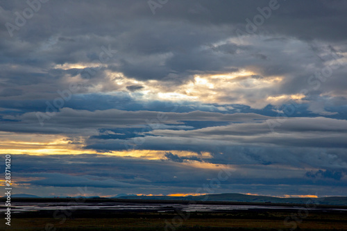 Unrealistic colorful sunset in the lush clouds in Iceland