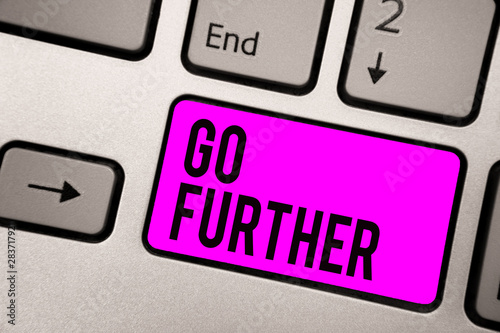 Text sign showing Go Further. Conceptual photo To move to a greater distance or overcome your limitations Keyboard purple key Intention create computer computing reflection document photo