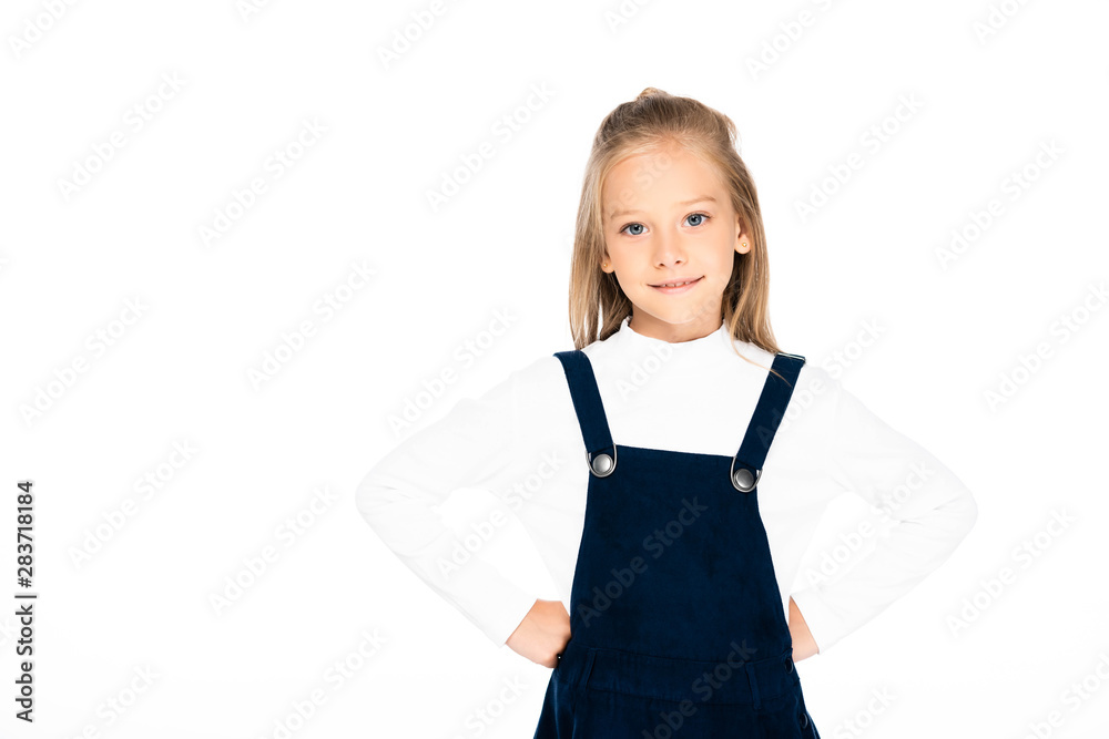 cute schoolgirl smiling while posing at camera with hands on hips isolated on white cute schoolgirl smiling while posing at camera with hands on hips isolated on white