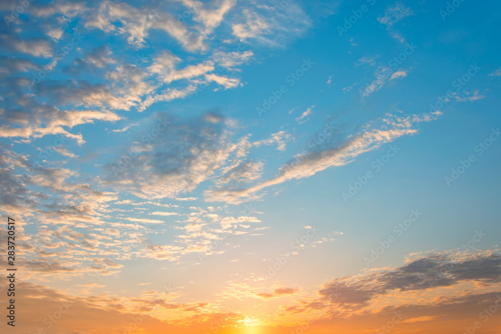 Beautiful sunrise sky with bright colors of nature, blue sky with orange sun and beautiful clouds.