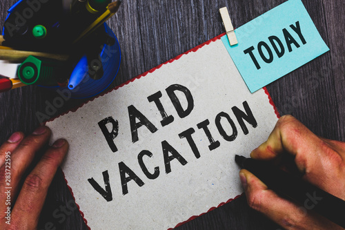 Conceptual hand writing showing Paid Vacation. Business photo text Sabbatical Weekend Off Holiday Time Off Benefits Man holding marker paper clothespin reminder cup marker wood table