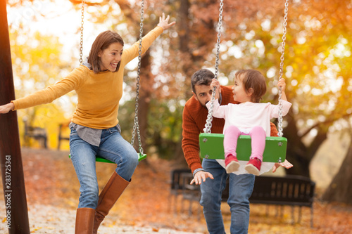 Parents with kid at swings