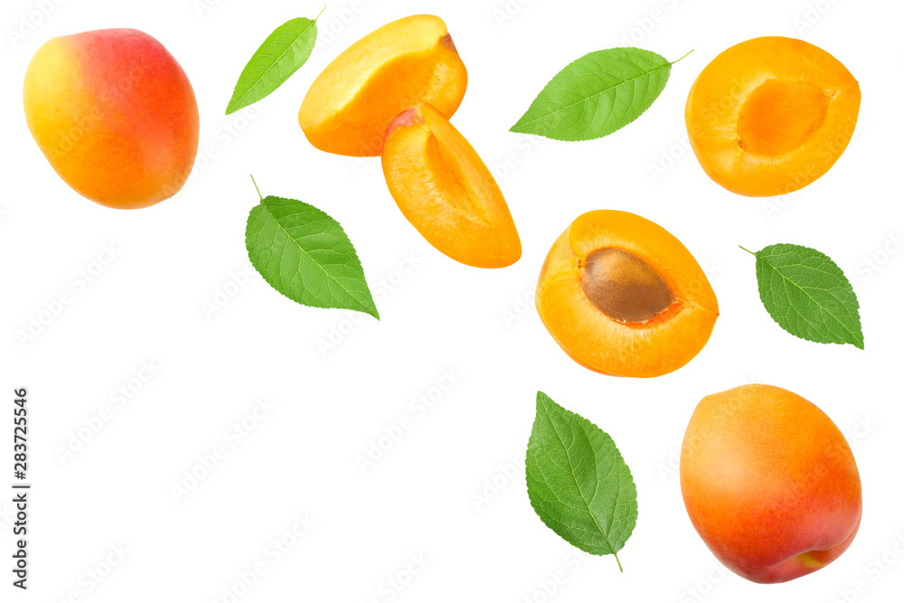 apricot fruits with slices and green leaf isolated on white background. top view