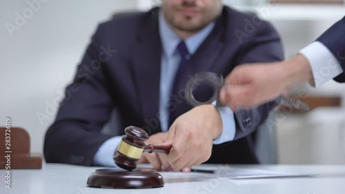 Venal judge handcuffed when passes unfair sentence, instant punishment for bribe