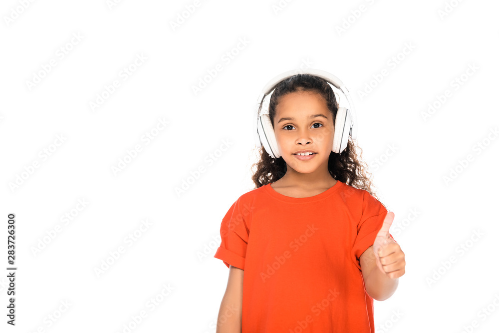 cute african american child showing thumb up while listening music in headphones isolated on white cute african american child showing thumb up while listening music in headphones isolated on white