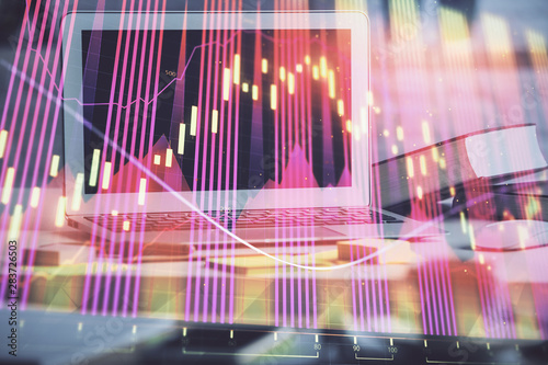 Financial chart drawing and table with computer on background. Double exposure. Concept of international markets.