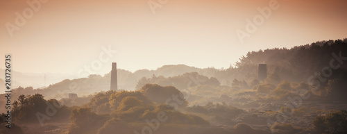 Engine houses from the industrial revolution in the mist at dawn.