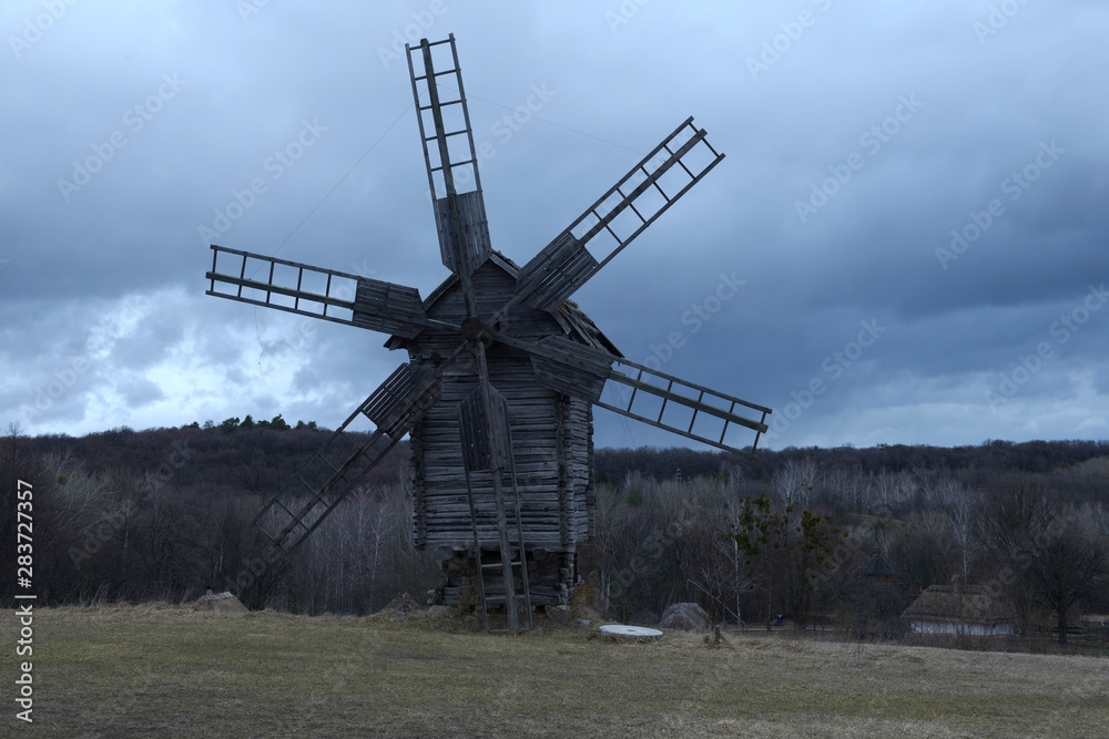 Old wooden windmill working in the evening light Old wooden windmill working in the evening light