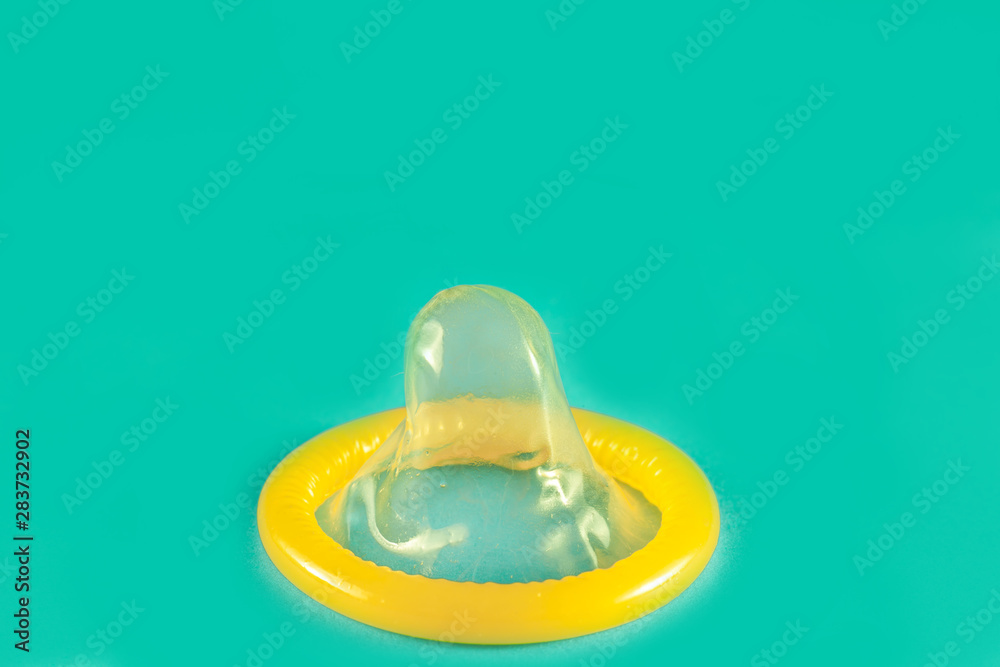 Fototapeta premium Close up shot of condom ready to use . give condom to safe sex concept . on the bed for Prevent infection.