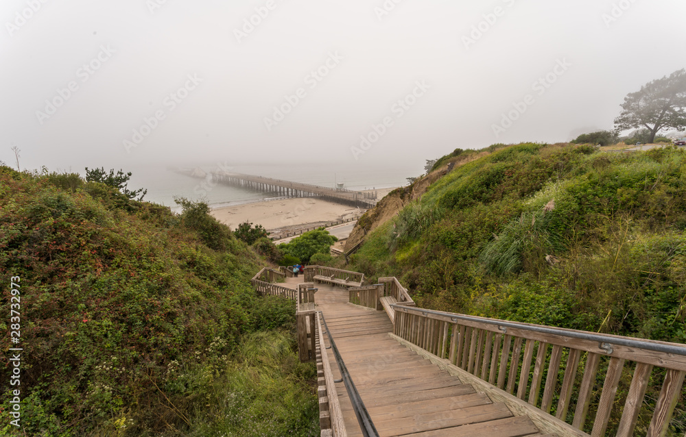 Aerial View of Long Wooden Stairs to the Beach With Fog over Pier Aerial View of Long Wooden Stairs to the Beach With Fog over Pier
