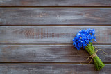 Summer design for blog with bouquet of blue cornflowers on wooden background top view copyspace