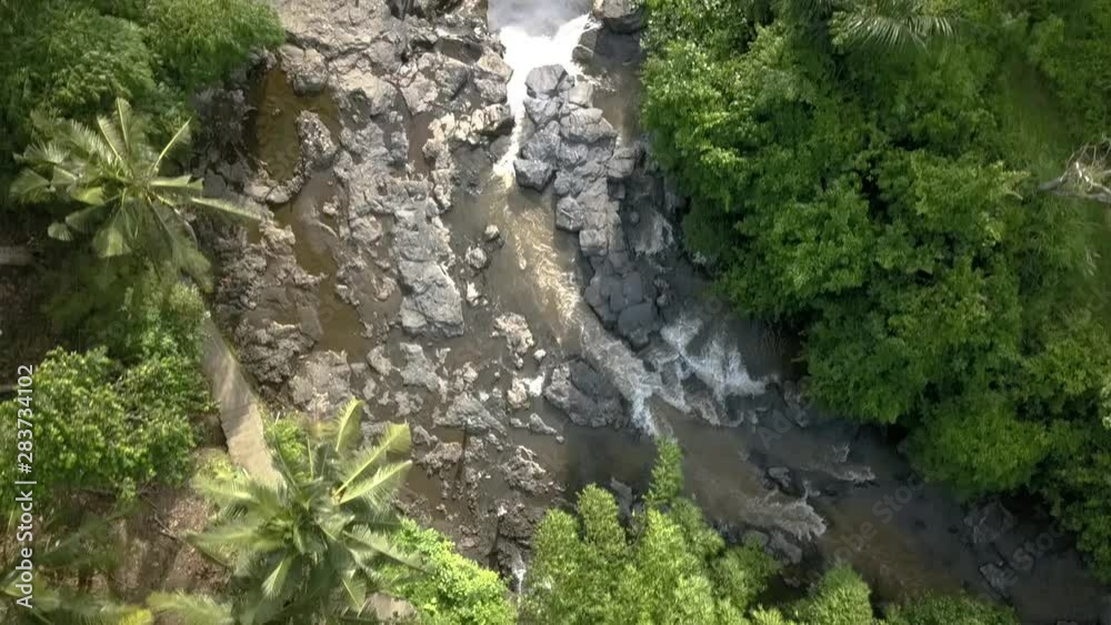 AERIAL TILT DOWN OVER WATERFALL of BALI , amazing river course to Tegenungan Waterfall, Indonesia, with surrounding rocks. Locking down AERIAL TILT DOWN OVER WATERFALL of BALI , amazing river course to Tegenungan Waterfall, Indonesia, with surrounding rocks. Locking down