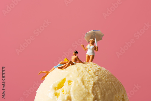miniature people in swimsuit on an ice cream