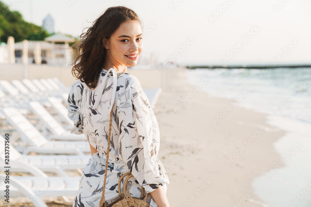 Pleased happy young beautiful woman at the beach running in a beautiful sunny morning. Pleased happy young beautiful woman at the beach running in a beautiful sunny morning.