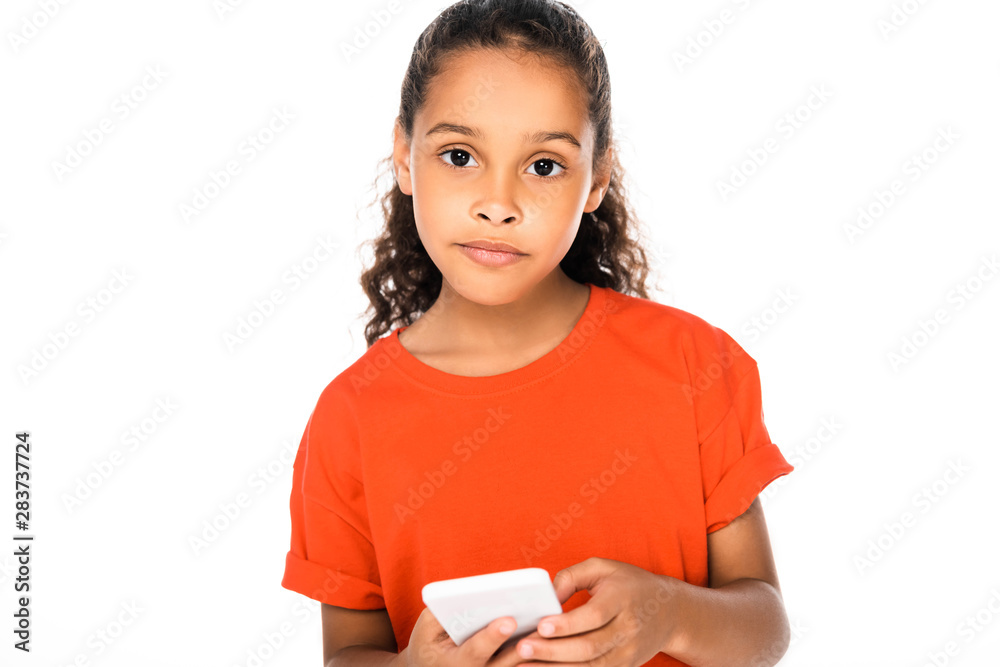adorable african american child looking at camera while using smartphone isolated on white adorable african american child looking at camera while using smartphone isolated on white