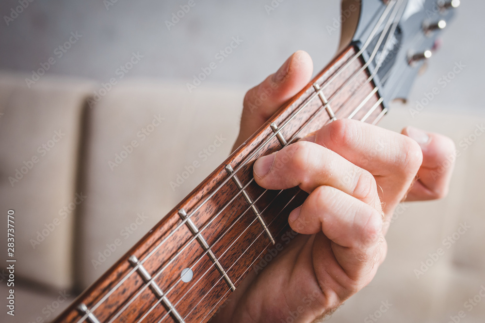 Cmaj7 chord - close-up male Caucasian hand takes a chord on a 6 string guitar Cmaj7 chord - close-up male Caucasian hand takes a chord on a 6 string guitar