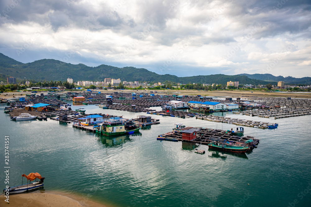 A fishing village of fishermans on the sea water in island Hainan in China