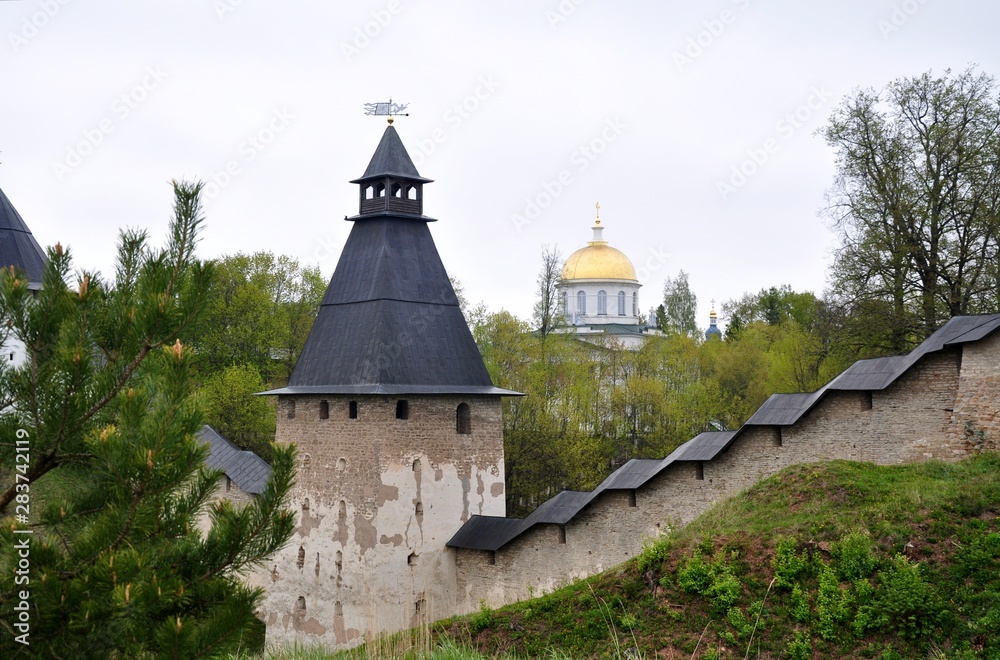 Ancient castle in Pechory Russia with church. Big wall and tower