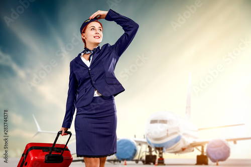 Young stewardess and airplane  photo