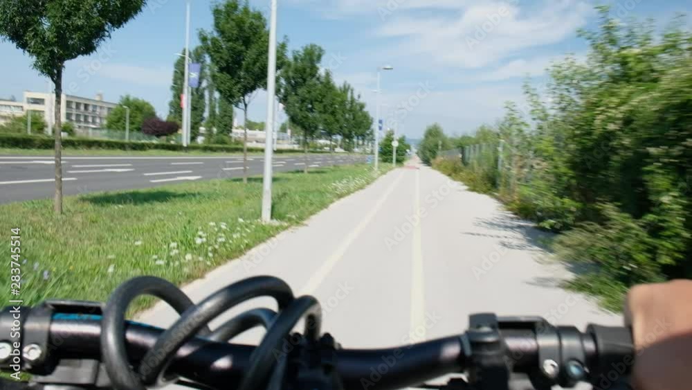 Man cycling in the city, point of view, steering wheel detail Man cycling in the city, point of view, steering wheel detail