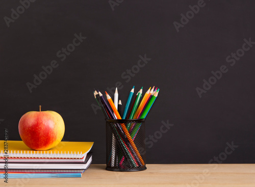 Apple, pencils and notebooks ready for using