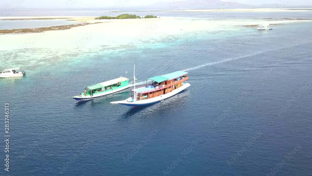 Aerial view with boat sailing at komodo national park (Komodo Island) of West Nusa Tenggara Indonesia Aerial view with boat sailing at komodo national park (Komodo Island) of West Nusa Tenggara Indonesia