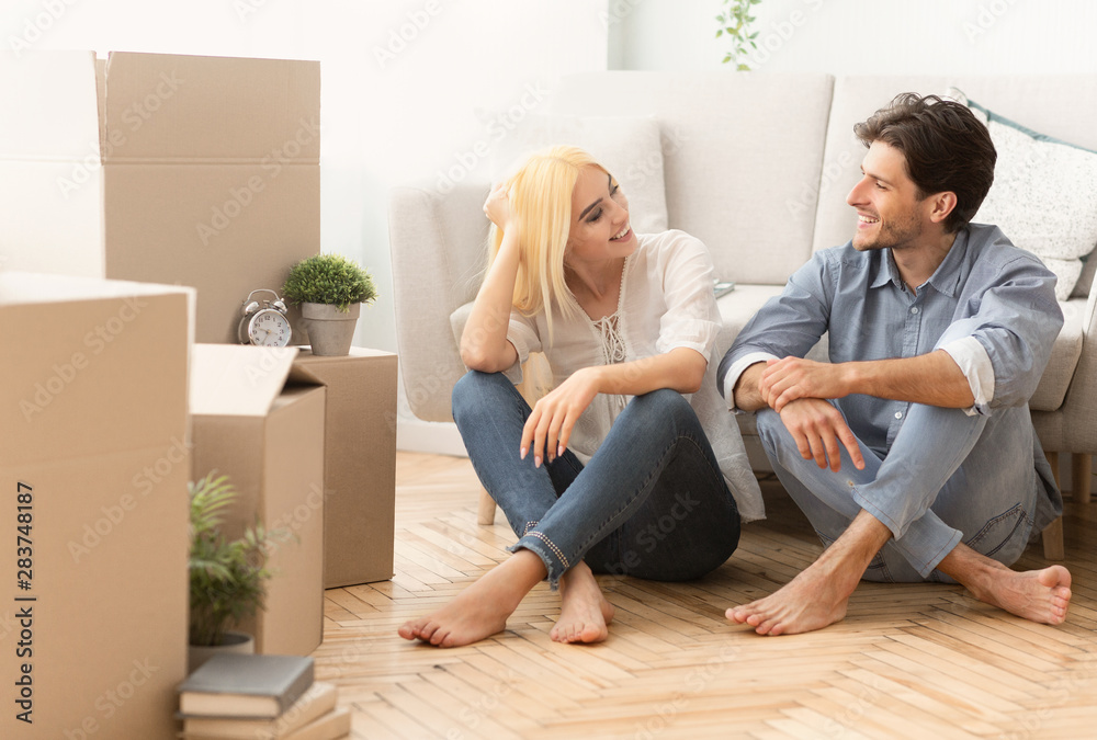 Smiling Couple Talking Sitting On Floor Moving Into New Apartment Smiling Couple Talking Sitting On Floor Moving Into New Apartment