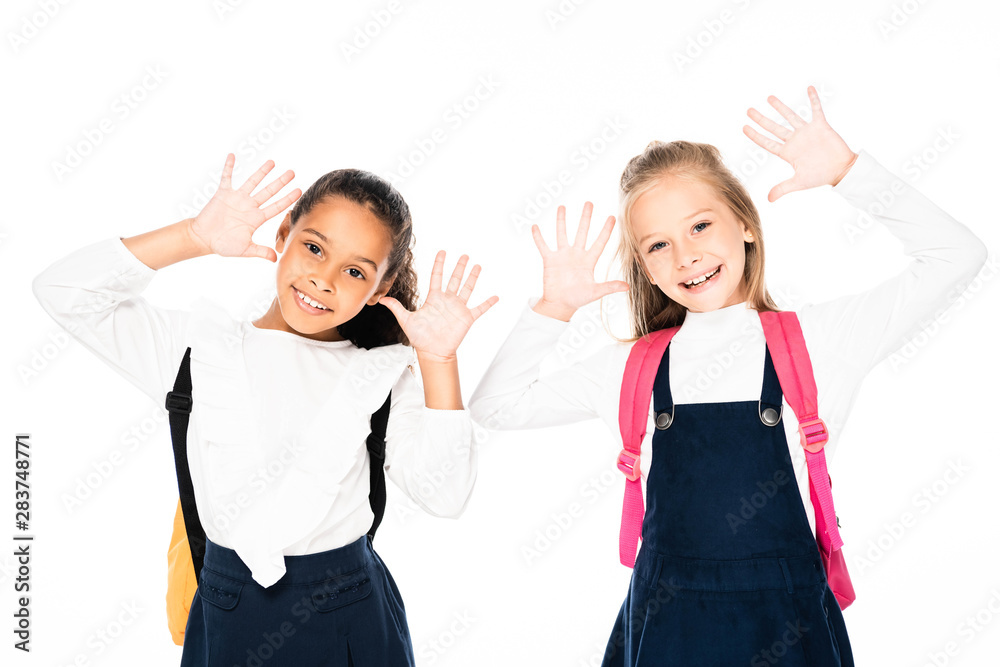 two smiling multicultural schoolgirls showing chalk stained hands isolated on white isolated on white two smiling multicultural schoolgirls showing chalk stained hands isolated on white isolated on white